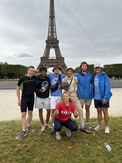 A group poses in front of the eiffel tower after their tour de france ride