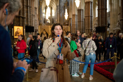 A guide leading a tour inside Westminster Abbey