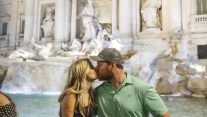 A couple kisses in front of the Trevi Fountain in Rome, Italy