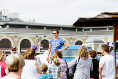 A guide addresses the group in Versailles