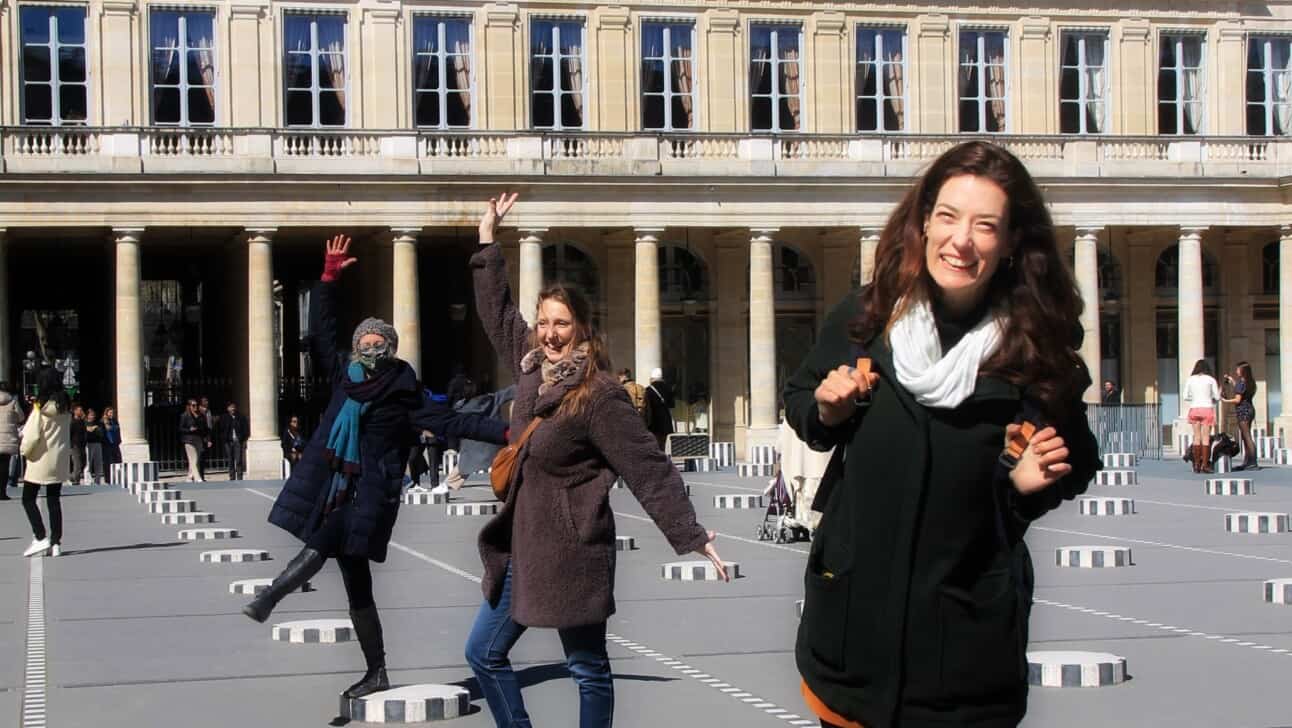 3 women pose on the black and white pedestals in Paris' Palais Royal