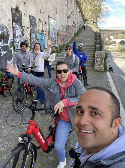 A group of cyclists alongside the river in Rome, Italy