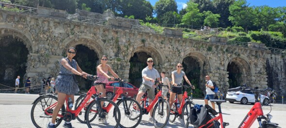 A group of 4 poses for a picture on red e-bikes in Florence