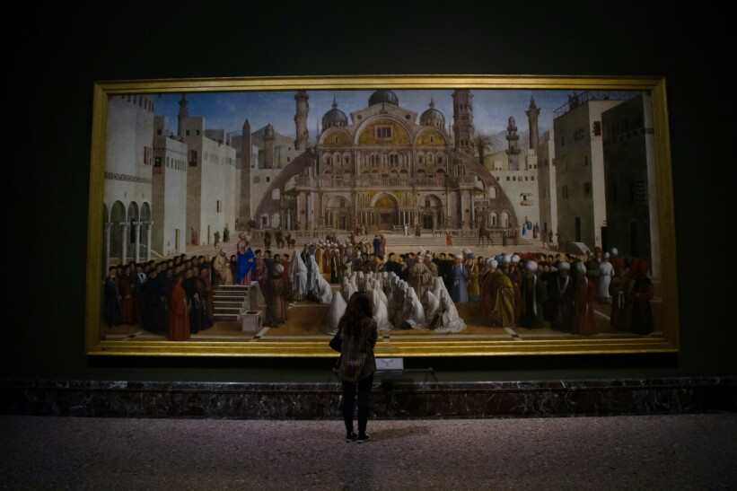 A woman marvels at a painting inside the Pinacoteca Ambrosiana in Milan, Italy
