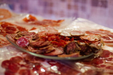 A close up of a plate of cured meat